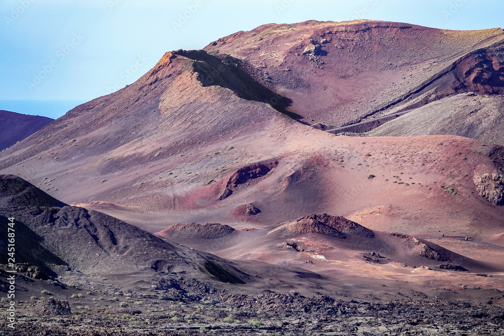 Beautiful volcanic landscape background. Mountain range with lava fields in the foreground. Lanzarote, Canary Islands.