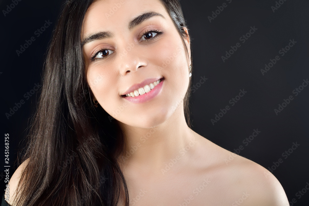 Portrait of a beautiful girl on a black background which is naked on the shoulders Portrait of a beautiful girl on a black background which is naked on the shoulders