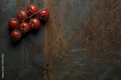Tomatoes on old iron background