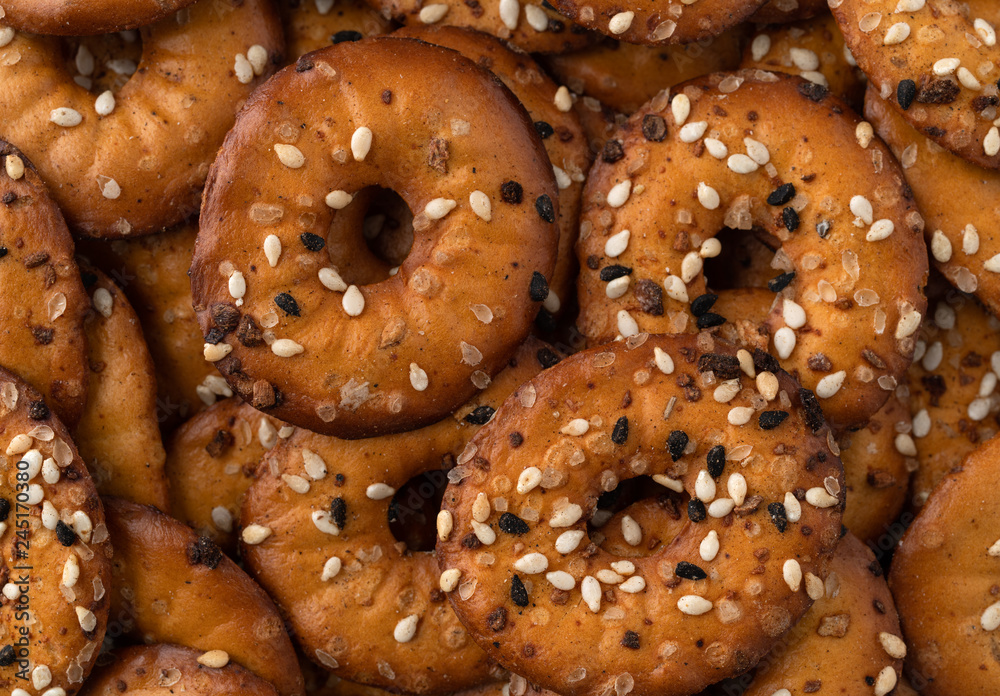 Close view of bite size bagel chips with seeds Close view of bite size bagel chips with seeds
