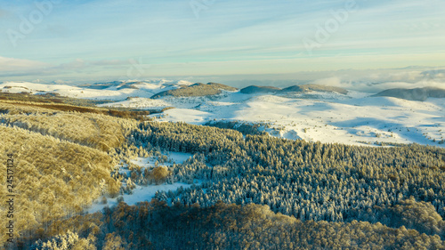 Aerial view of a gold sunset over winter snow. © Grigor