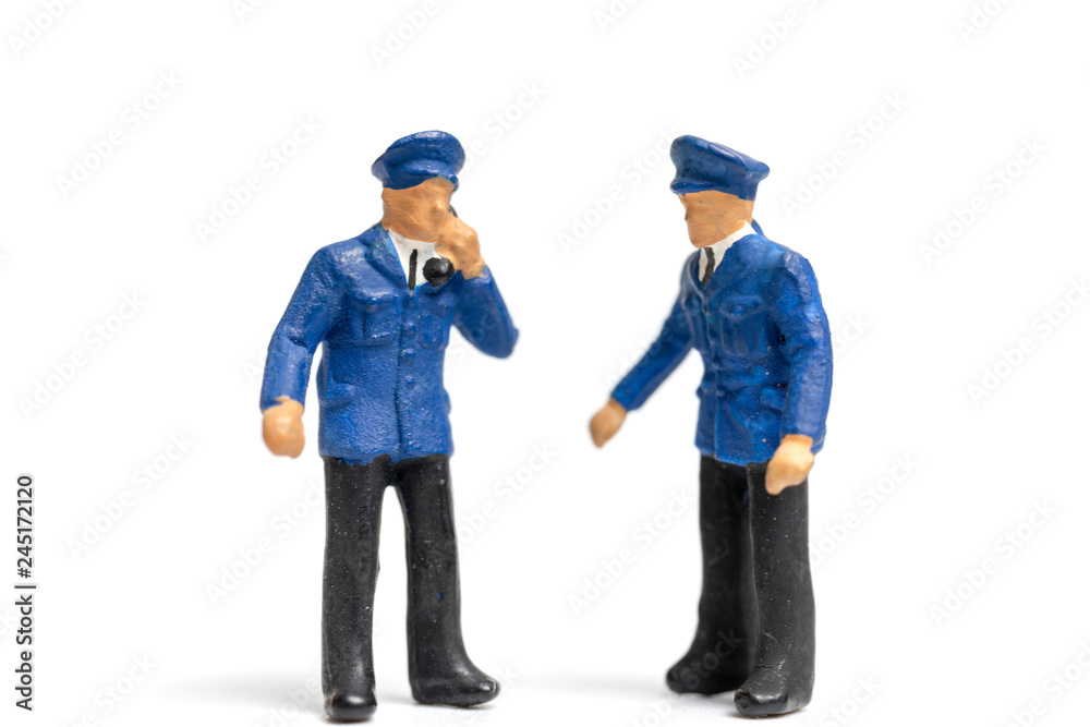 Miniature people : Policeman standing on white background