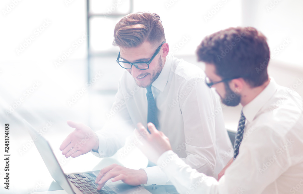 business colleagues using a laptop to check data business colleagues using a laptop to check data
