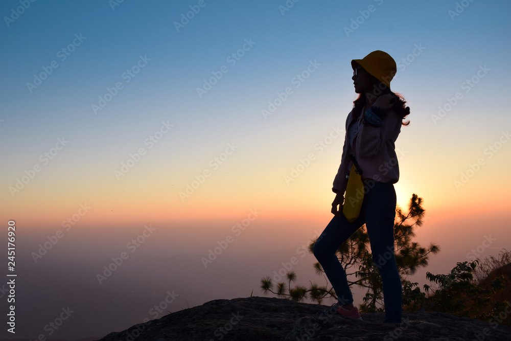 silhouette woman stand on mountain with sunset