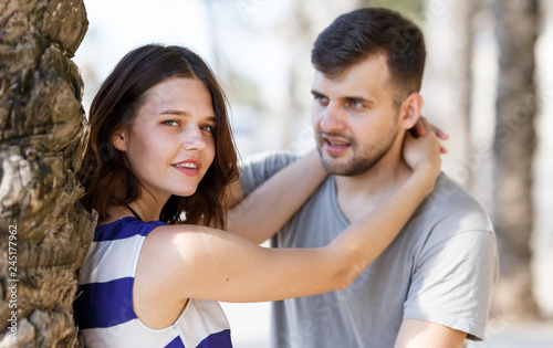 Man and girl talking and hugging