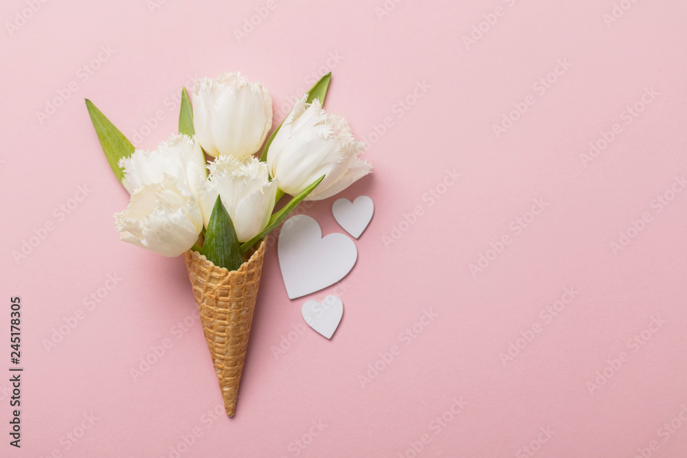 Fototapeta Flat-lay waffle cone with white flower blossom