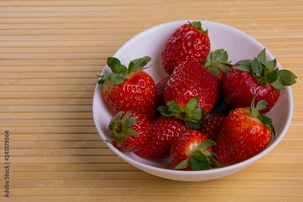 Strawberry in white plate close-up on light background 2 Strawberry in white plate close-up on light background 2