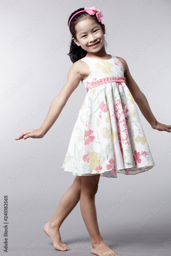Naklejka premium Cute Asian Chinese little girl indoors against white background