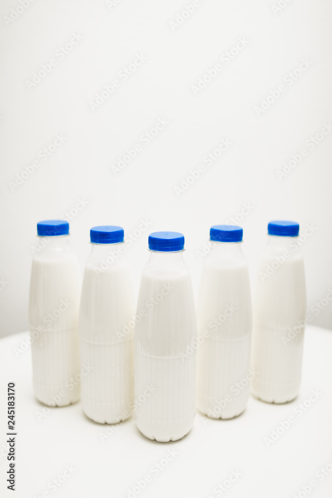 milk bottles on white table milk bottles on white table