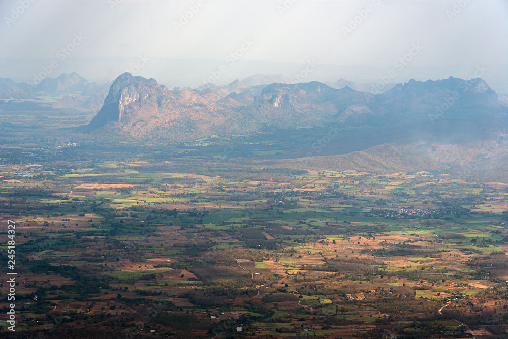 Agricultural plain and mountain range with light and shadow
