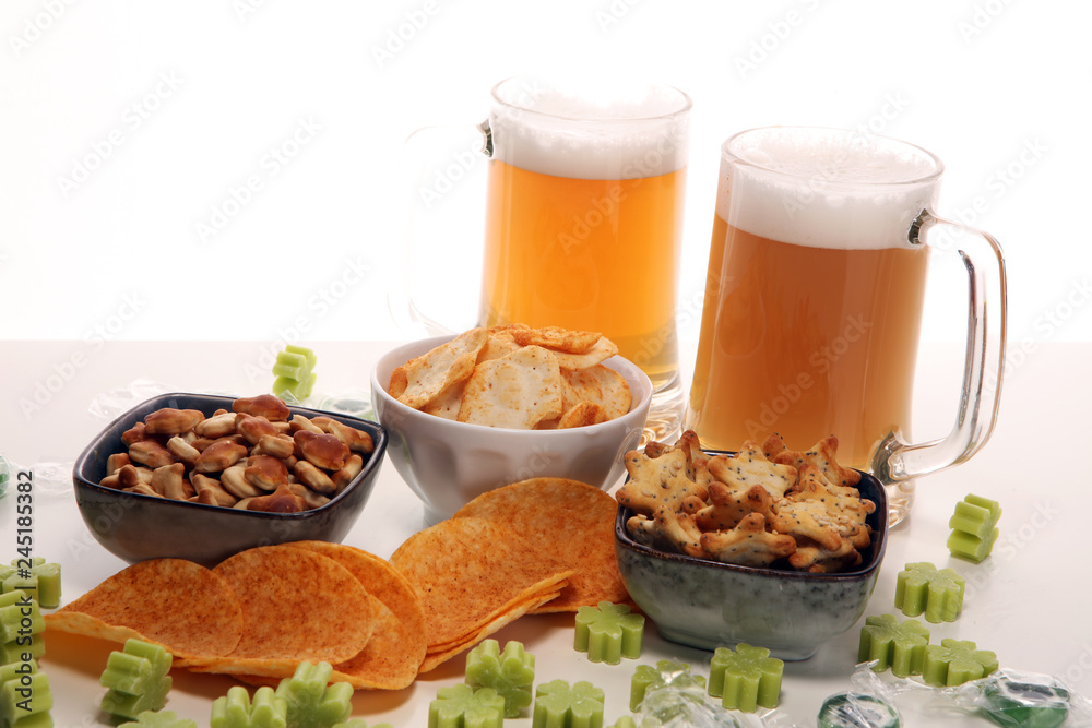 st patricks day with Chips, salty snacks, and Beer on a table. Saint celebration with lucky shamrock