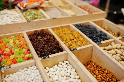 Raisins, nuts and candied fruits on the shelf of a supermarket or grocery store.