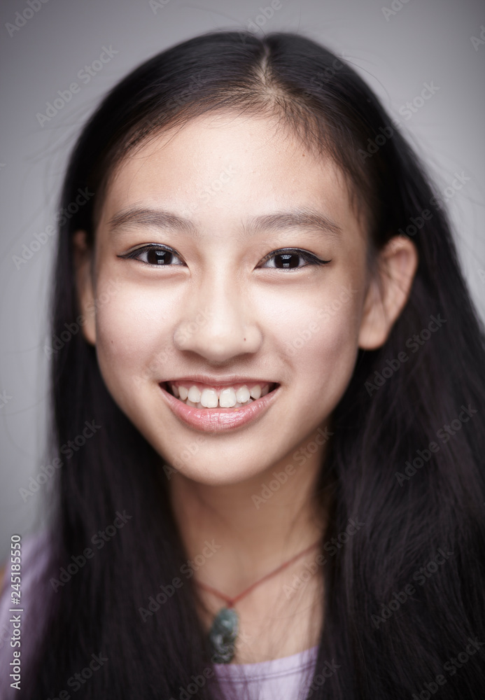 Asian teenage girl portrait. Indoors white background Asian teenage girl portrait. Indoors white background