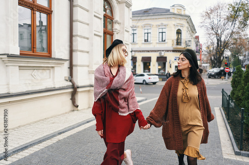 Carefree pretty autumn cool girls on city street