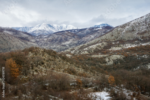 View of mountain range of Dinaric Alps on cloudy winter day. Montenegro, Sitnica region