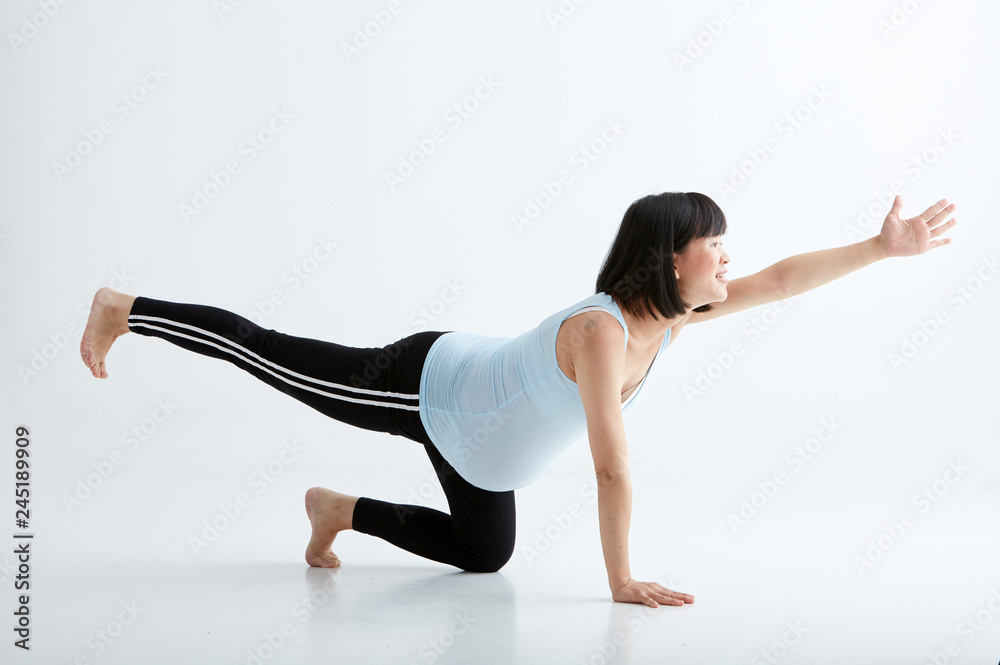 Asian pregnant woman drinking water,white background in studio Asian pregnant woman drinking water,white background in studio