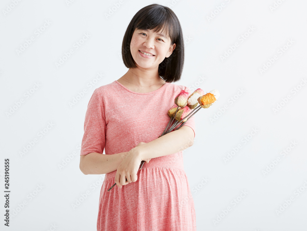 Pregnant women with flowers,White background in studio Pregnant women with flowers,White background in studio