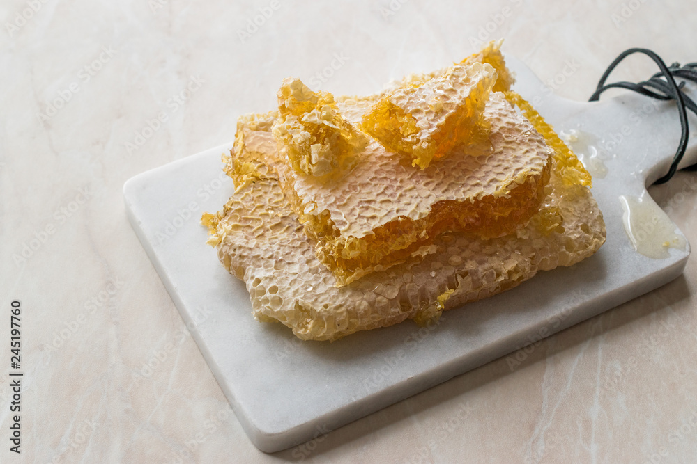 Fresh Honeycomb Slices with Honey on Marble Board. Fresh Honeycomb Slices with Honey on Marble Board.