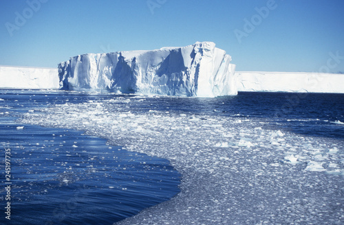 Antarctica; an iceberg from the plateau drifting along photo