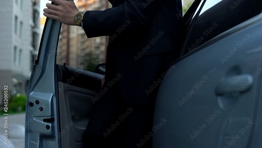 Tired man getting out of car, returning home from work, daily routine, closeup Tired man getting out of car, returning home from work, daily routine, closeup
