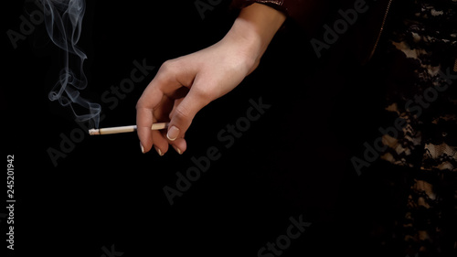 Lady smoking cigarette alone, bad habits among youth, infertility risk, close up