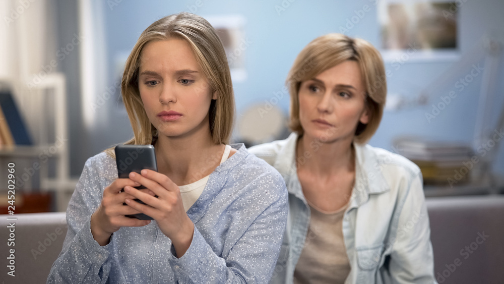 Addicted to smartphone daughter avoiding family talk with mother, naughty child Addicted to smartphone daughter avoiding family talk with mother, naughty child