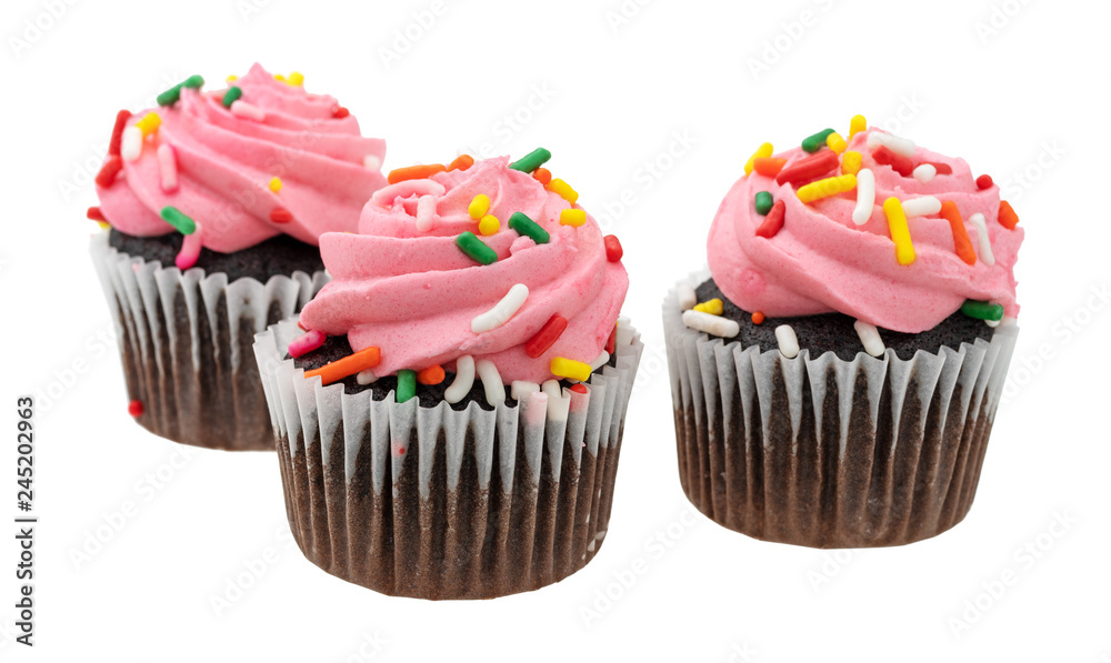 Three pink frosted chocolate cupcakes isolated on a white background side view.