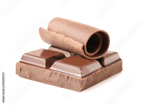Yummy chocolate curl and piece on white background