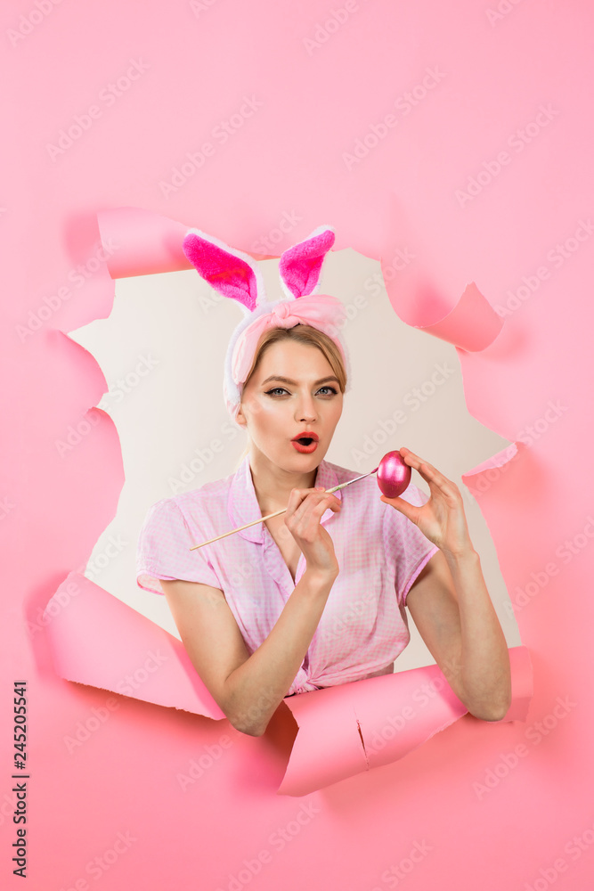 Happy easter! Easter Day. Woman peeks through paper. Pin up girl with bunny ears. Woman breaks paper. Through paper. Surprised woman painting egg. Painting eggs for Easter. Happy easter! Easter Day. Woman peeks through paper. Pin up girl with bunny ears. Woman breaks paper. Through paper. Surprised woman painting egg. Painting eggs for Easter.