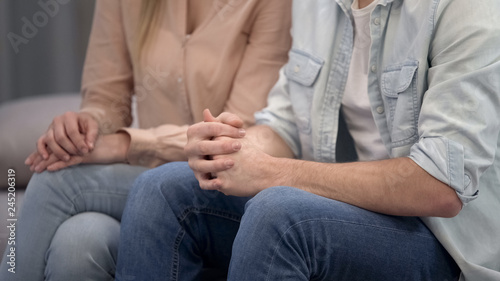 Couple sitting at psychologist, family crisis therapy, marriage counseling