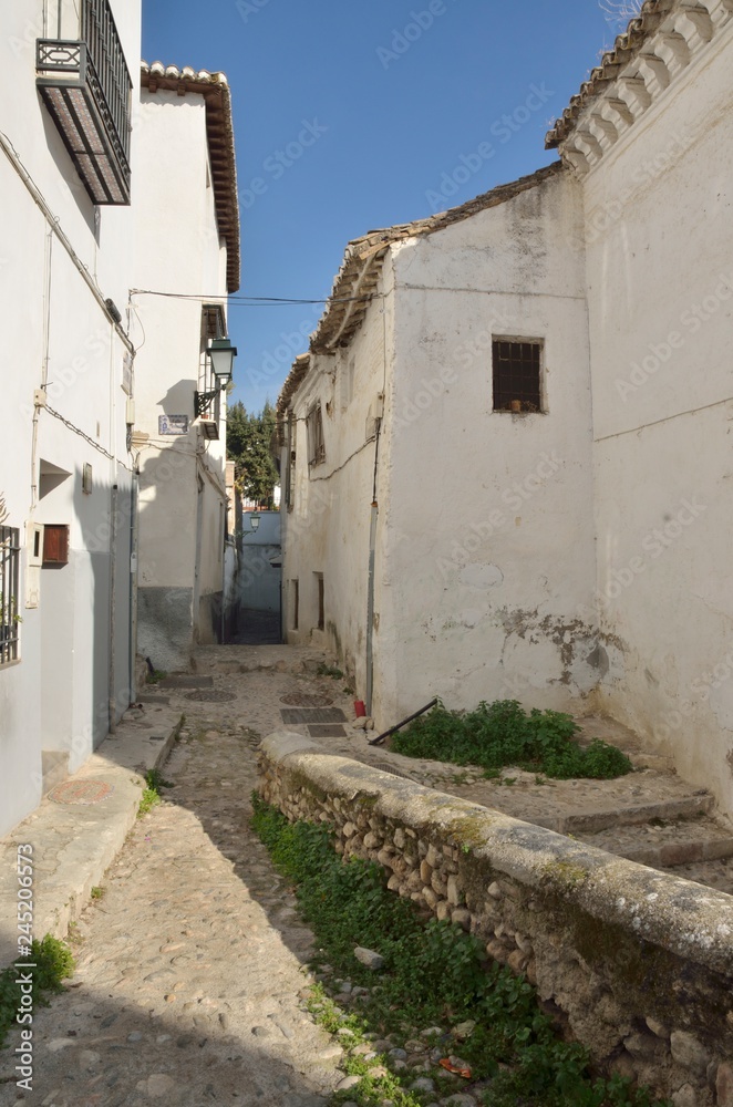 White houses in stone alley, Granada, Spain