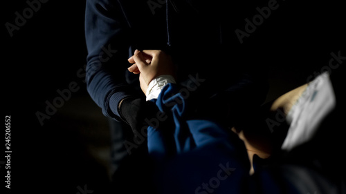 Konstfotografi Male criminal opening car trunk and checking female victim pulse, kidnapping
