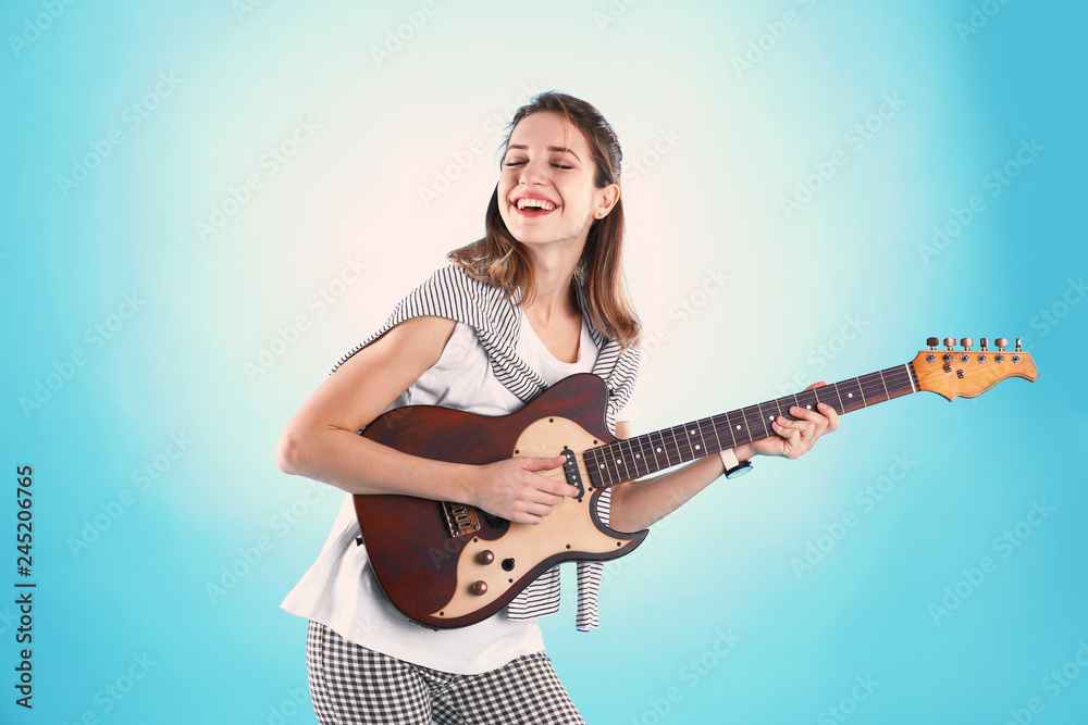 Young woman playing electric guitar on color background Young woman playing electric guitar on color background