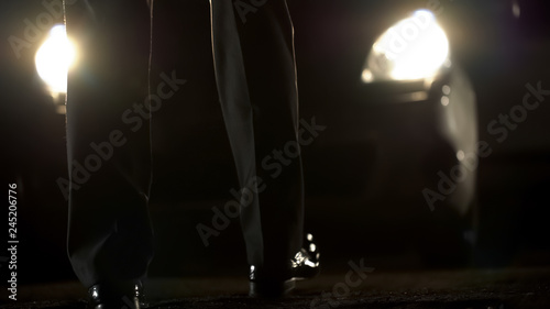 Photos Man in business suit slowly walking to expensive car, shadow deals, collusion