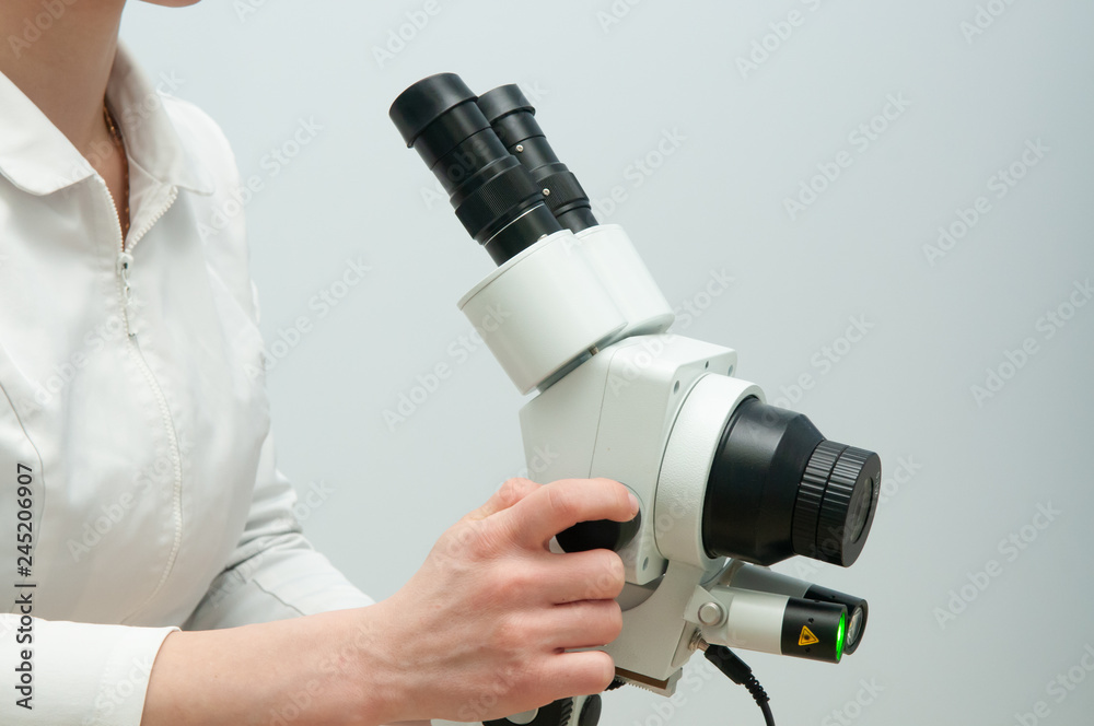 Gynecologist working with colposcope in clinic Gynecologist working with colposcope in clinic