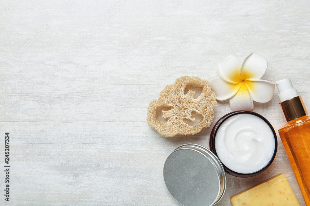 Flat lay composition with body care products and space for text on light background