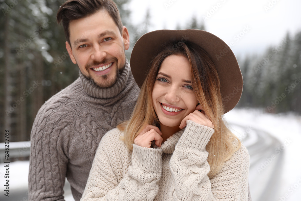 Cute couple outdoors on snowy day. Winter vacation Cute couple outdoors on snowy day. Winter vacation