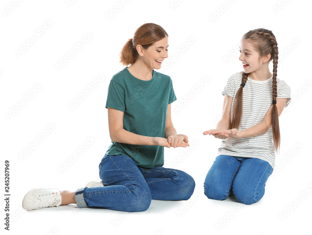Fototapeta premium Hearing impaired mother and her child talking with help of sign language on white background