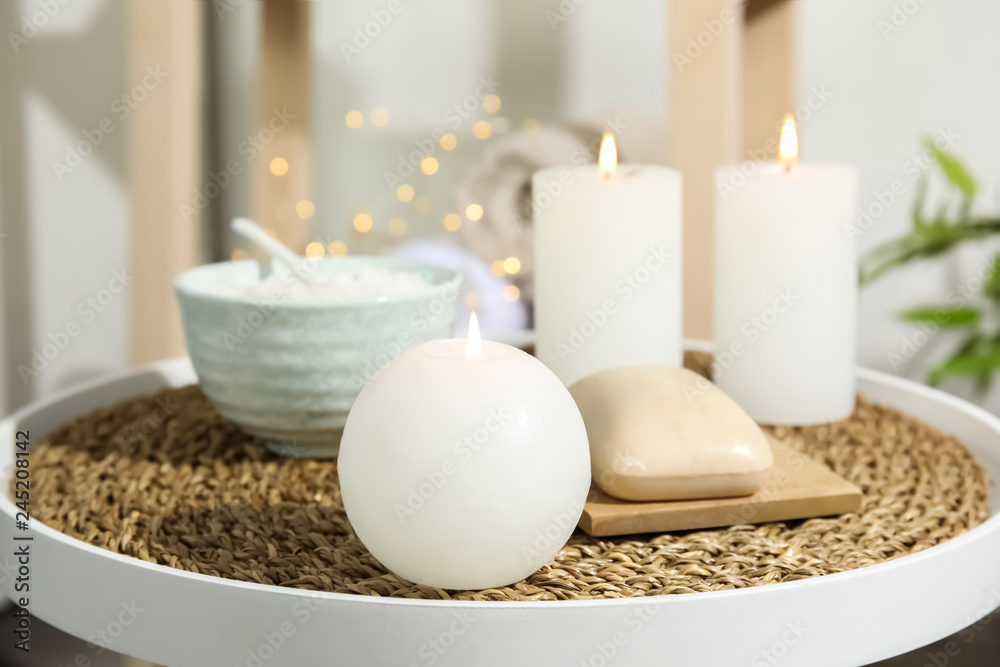 Beautiful spa composition with candles and cosmetic on table