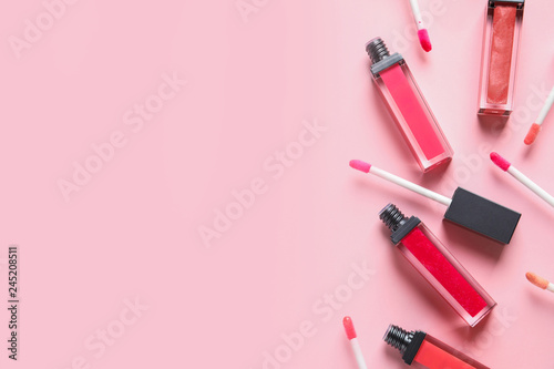 Beautiful flat lay composition of liquid lipsticks and space for text on color background