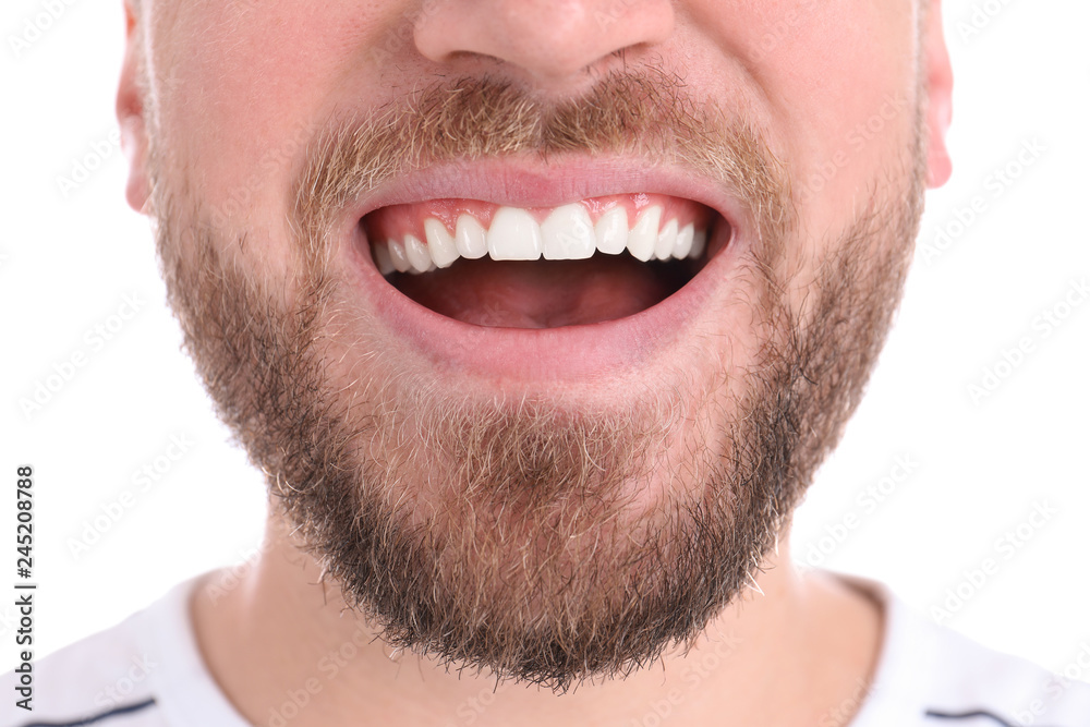 Young man with healthy teeth smiling on white background, closeup Young man with healthy teeth smiling on white background, closeup