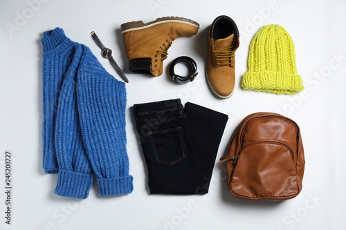 Flat lay composition with female winter clothes on white background