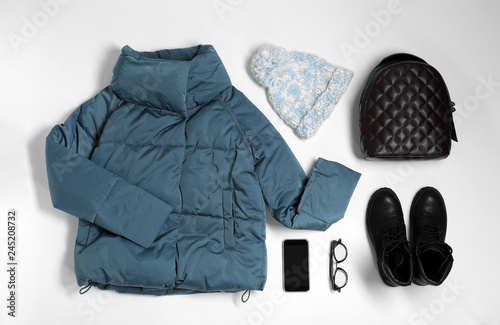 Flat lay composition with female winter clothes on white background