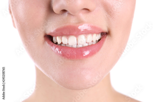 Young woman with healthy teeth smiling on white background  closeup