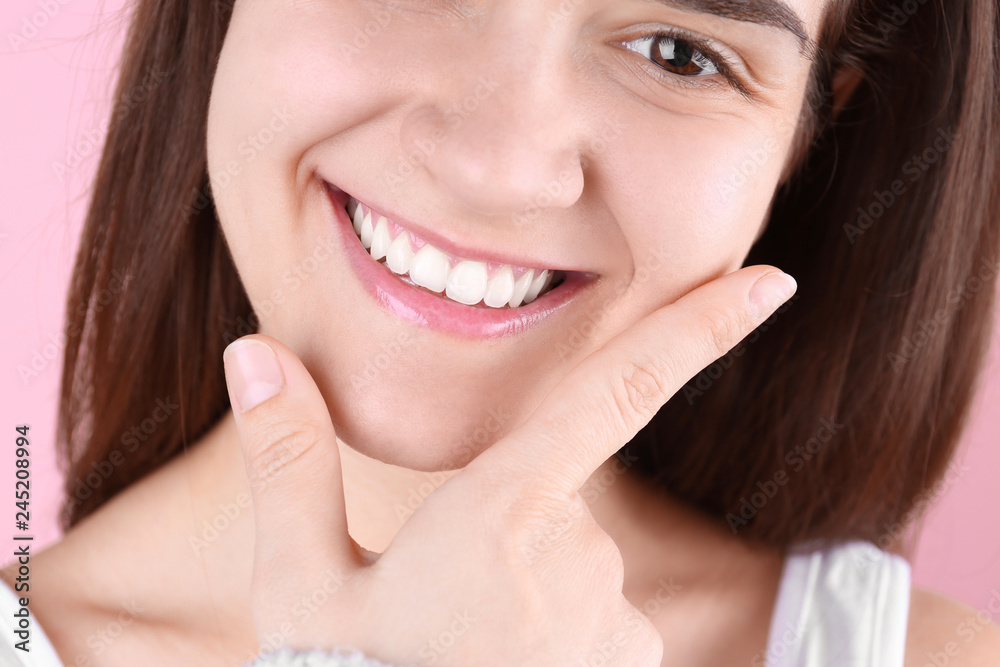 Young woman with beautiful smile on color background, closeup Young woman with beautiful smile on color background, closeup