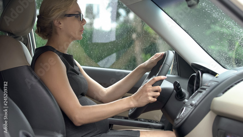 Elegant business lady learning how to drive car, trouble-free pregnancy, health