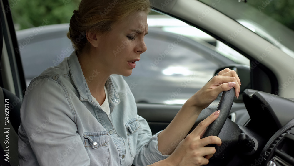 Middle-aged woman driving car suddenly feeling dizziness, risk of faint, health Middle-aged woman driving car suddenly feeling dizziness, risk of faint, health