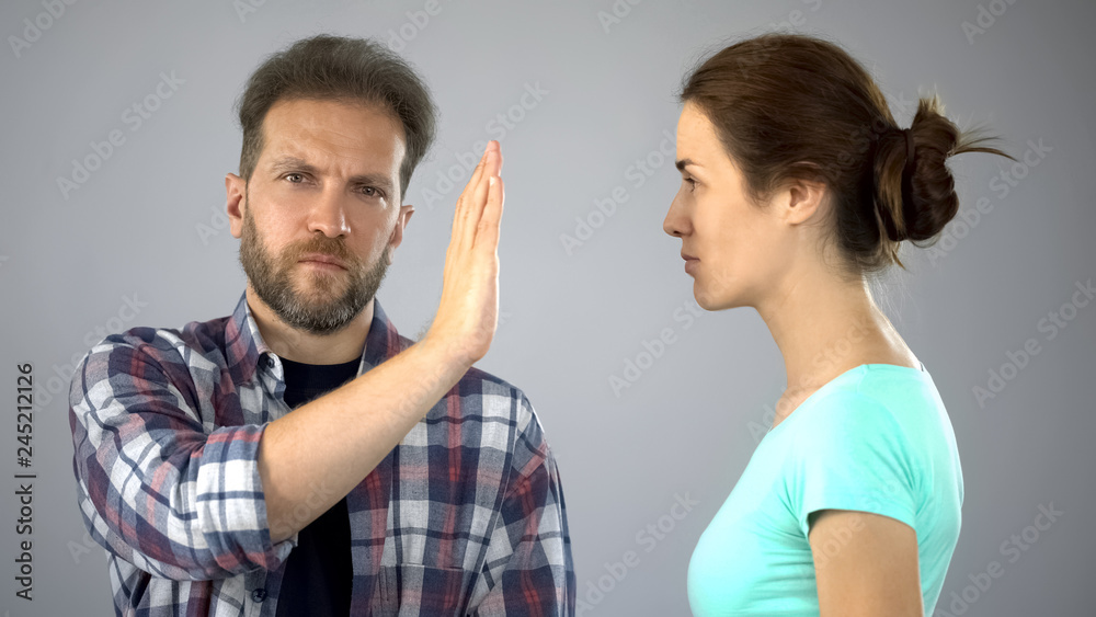 Αυτοκόλλητο Man showing stop sign to annoyed wife who constantly screaming and complaining