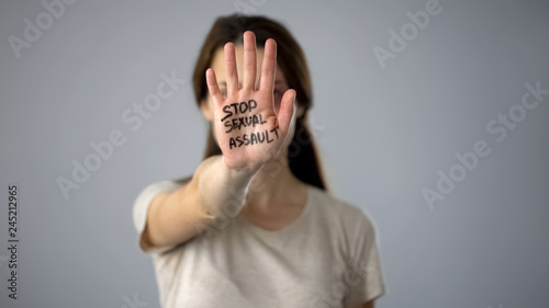Stop sexual assault sign on womans hand, discrimination prevention, assault photo