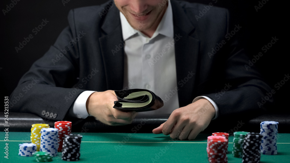 Happy male holding wallet full of money, jackpot prize, game fortune, gambling Happy male holding wallet full of money, jackpot prize, game fortune, gambling